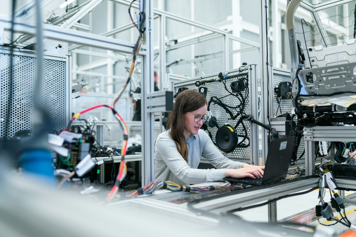 Manufacturing floor with technicians monitoring production equipment